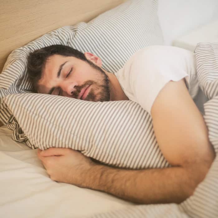 man sleeping well after treating sleep apnea
