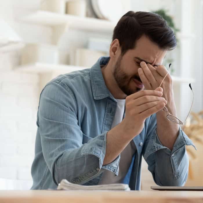 man experiencing headache from sleep apnea